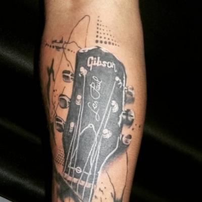 Tattoo bass guitar on hand. Guitar tattoos. Features of performance and different styles tattoo with a guitar